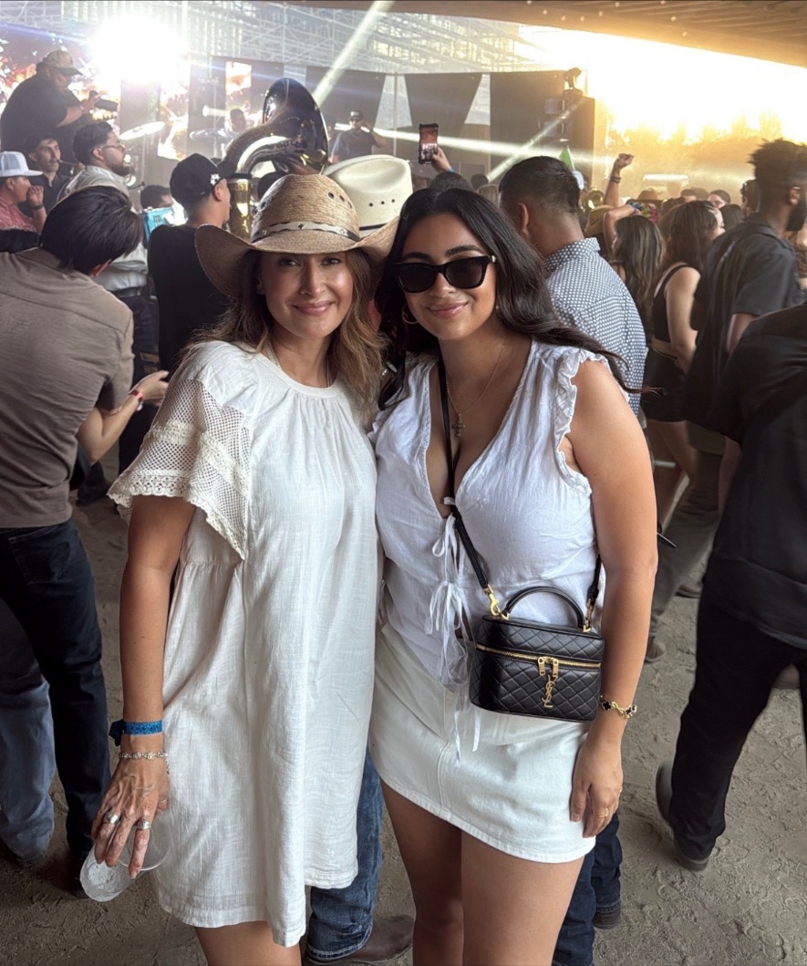 Mariah in a white dress with a crossbody bag